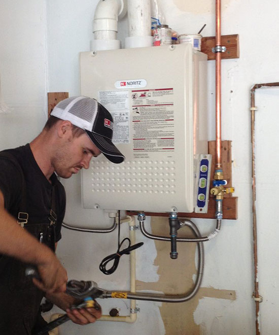 Drew Hamblen fixing water heater